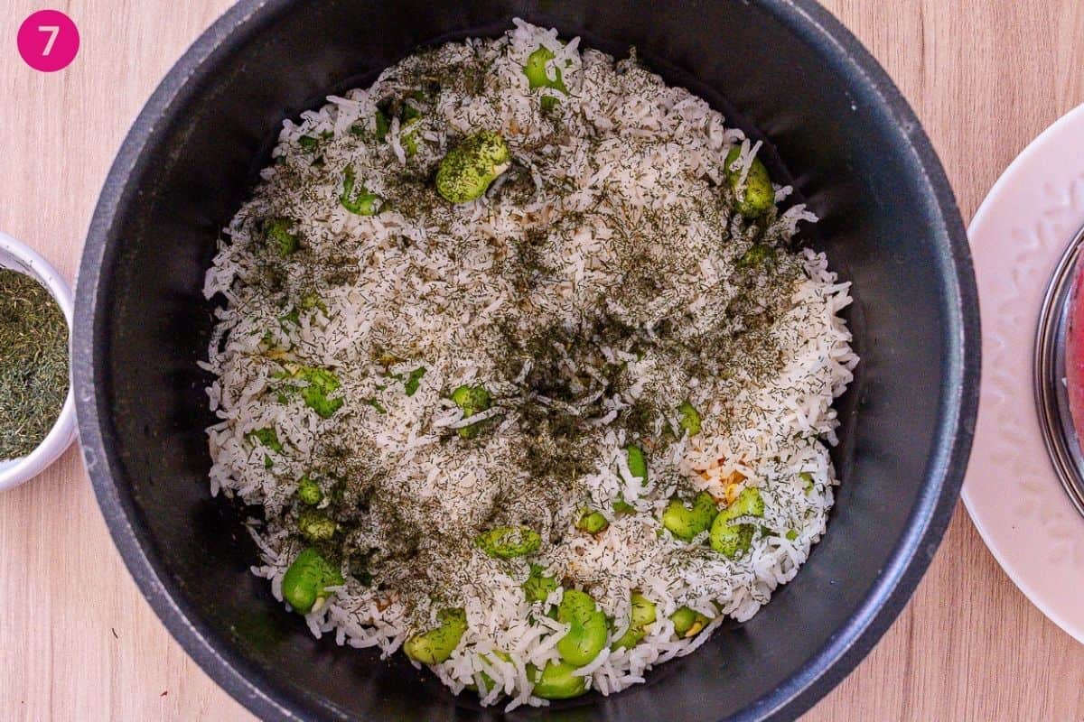 Layering of rice and herbs in a pot