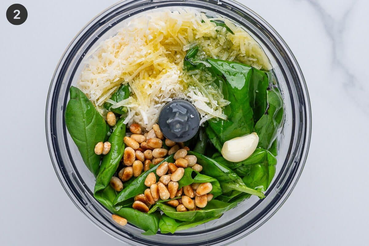 Pesto ingredients added to a blender