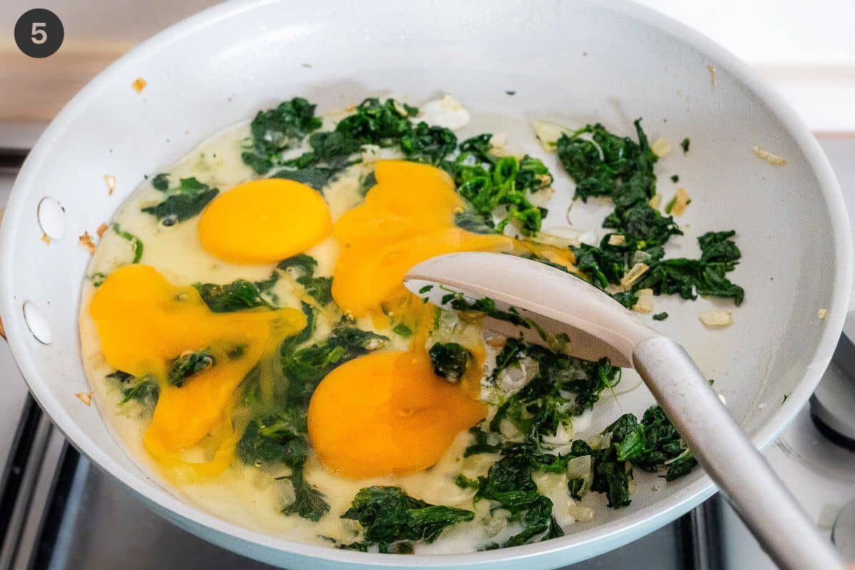 Eggs added to the pan and being scrambled