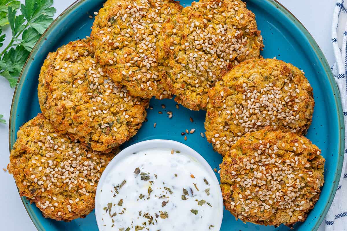 Chickpea fritters on a plate with Greek yogurt sauce