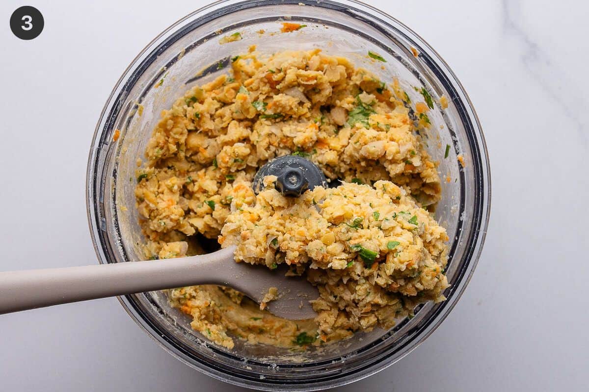 Spatula in blender to show fritter mixture