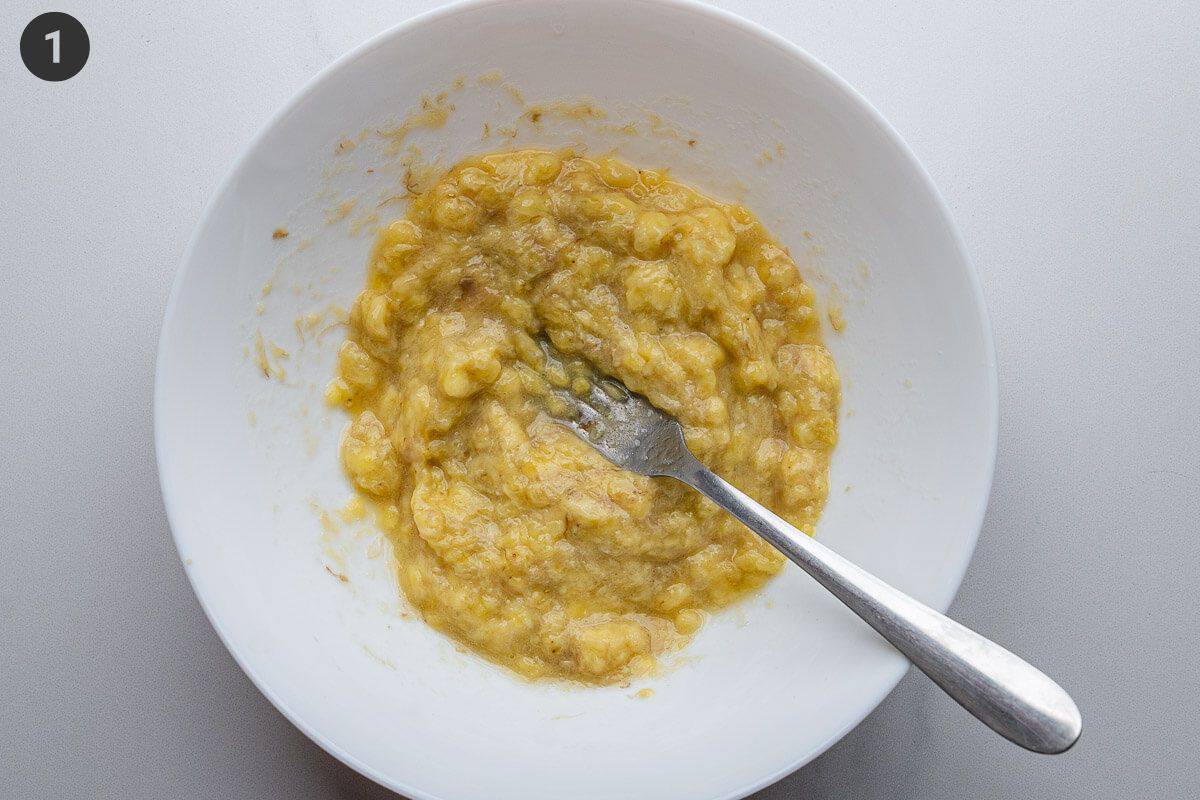 Ripe bananas being mashed with a fork