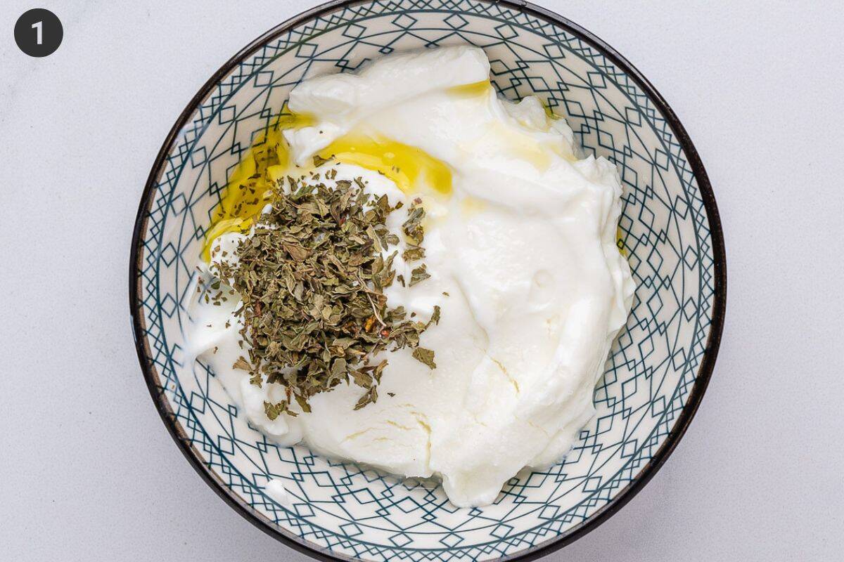 Yogurt sauce ingredients added to a small bowl before being mixed