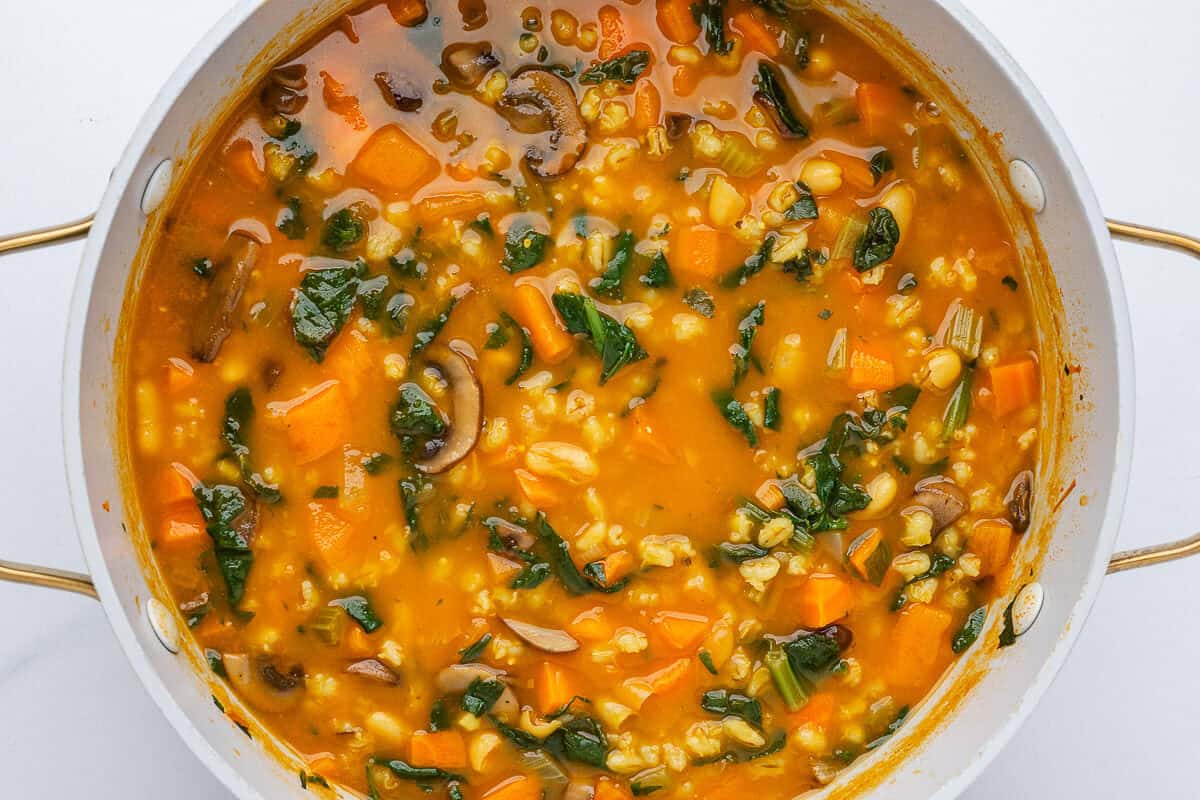 Vegetable barley soup in a large pot