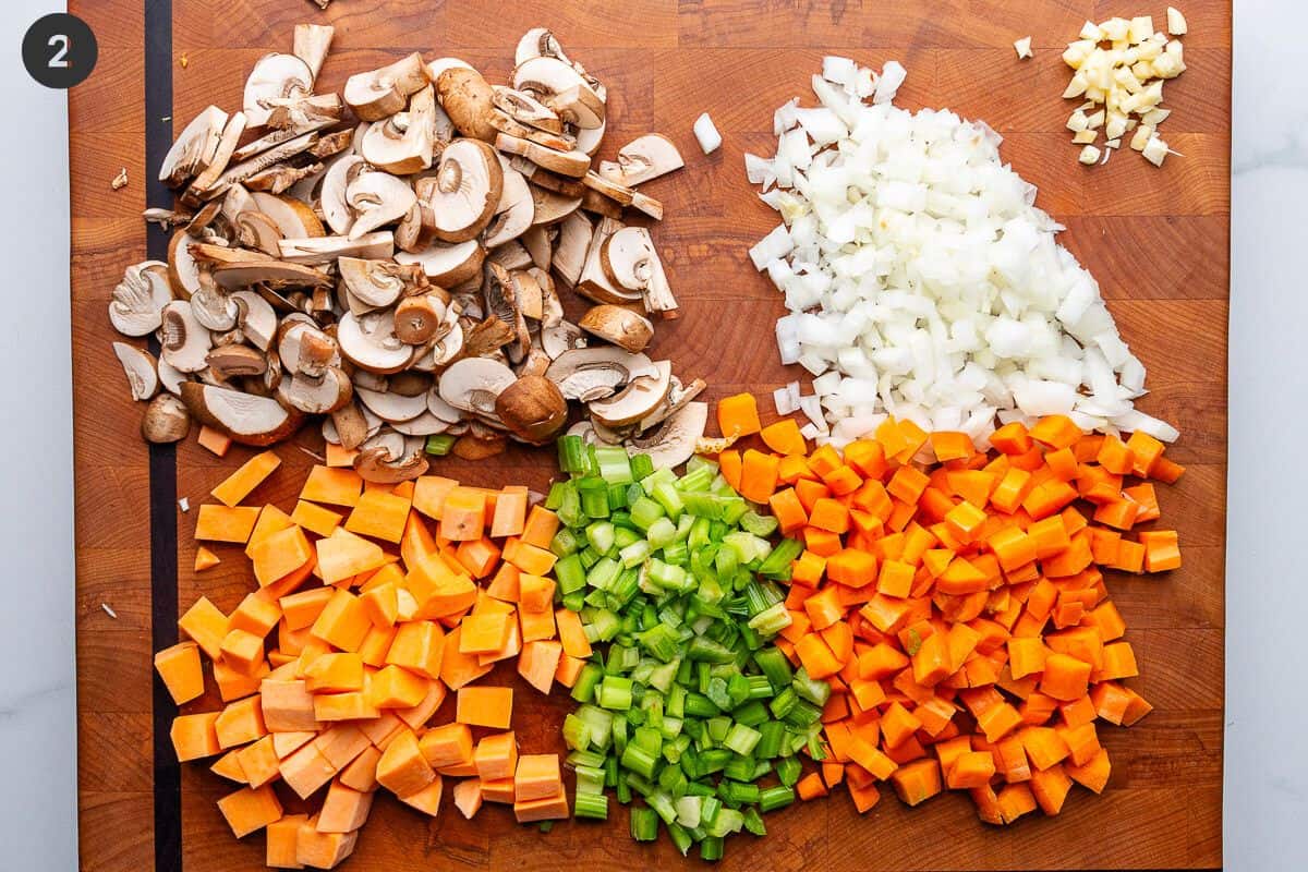 Vegetables and mushrooms chopped on a cutting board