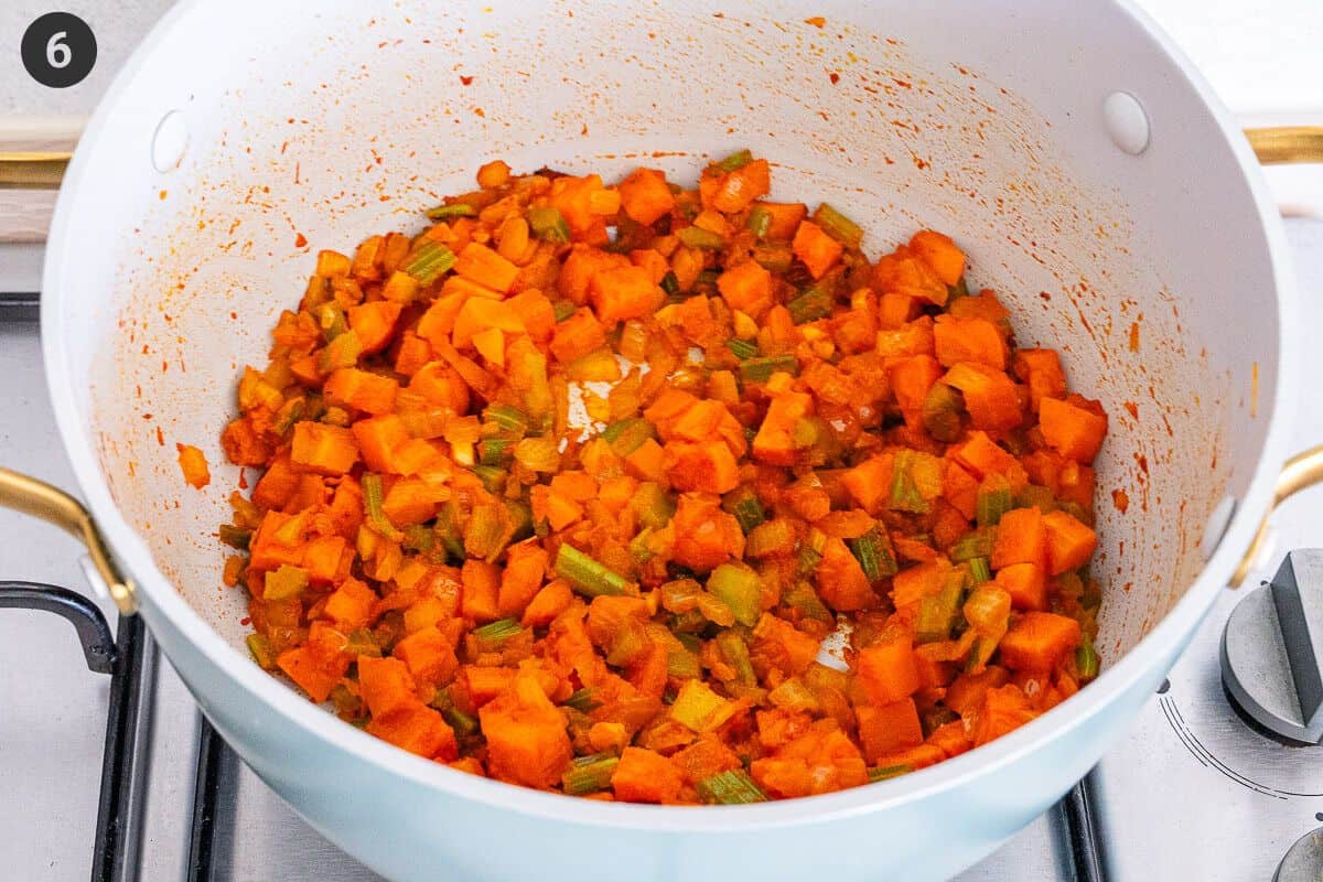 Tomato paste and garlic added to the pot