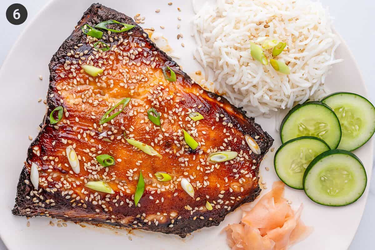 Miso salmon placed on a plate with ginger, cucumber and rice