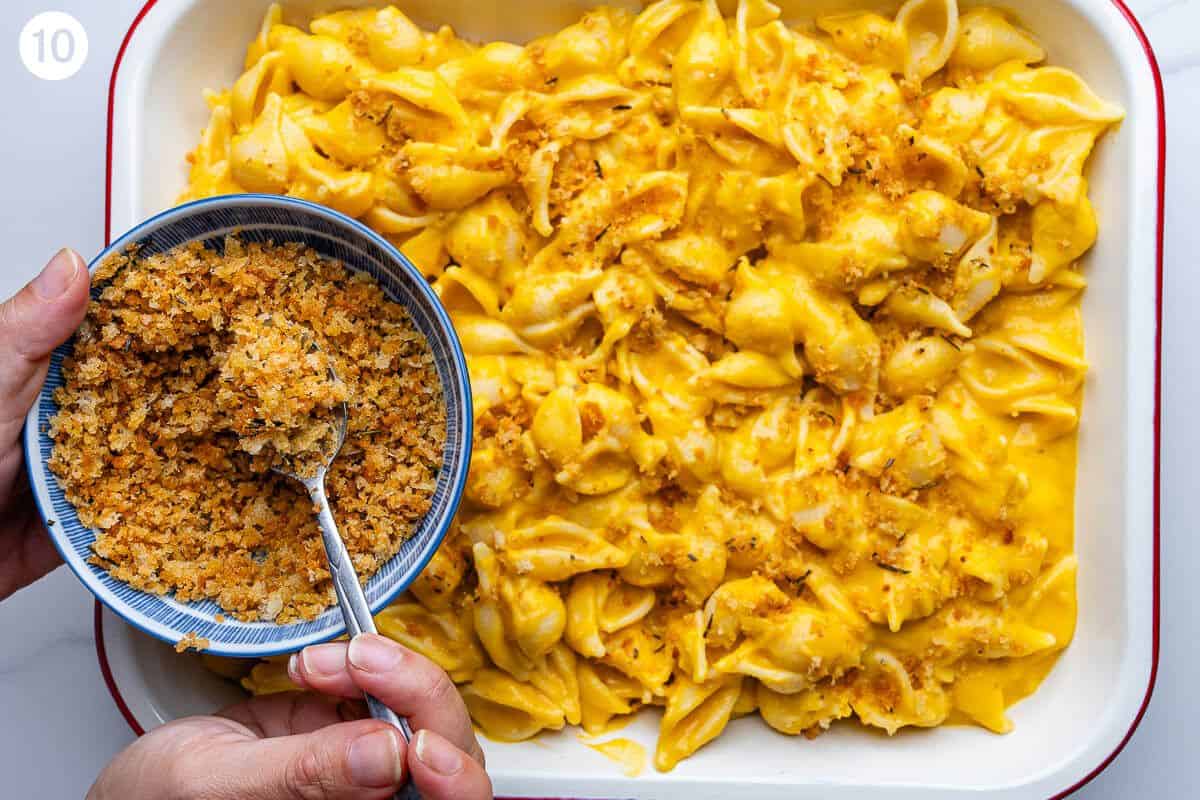 Pangrattato being sprinkled over creamy pasta