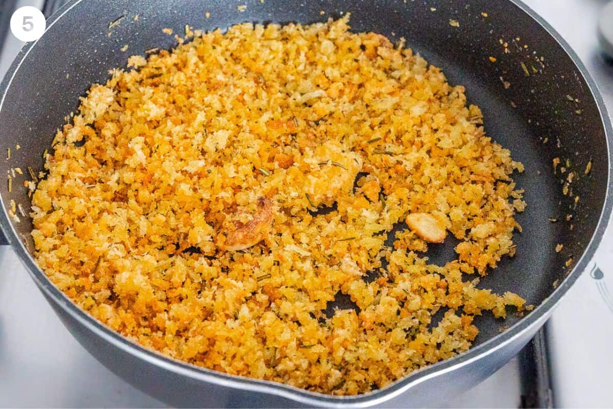 Constant stirring of pangrattato in a pan