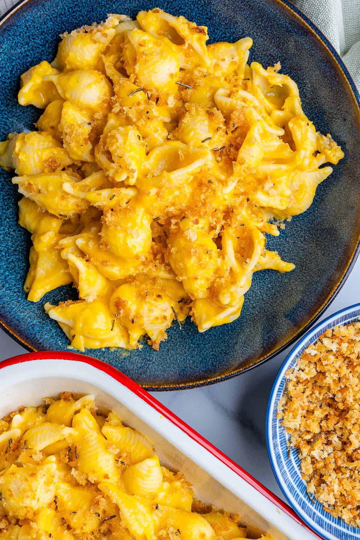 Butternut squash pasta served in a bowl with tray and pangrattato on the side