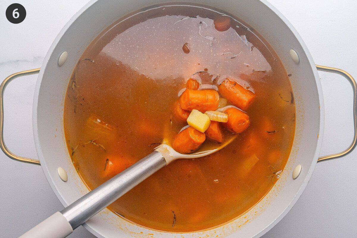 Roasted vegetables added to vegetable broth pot