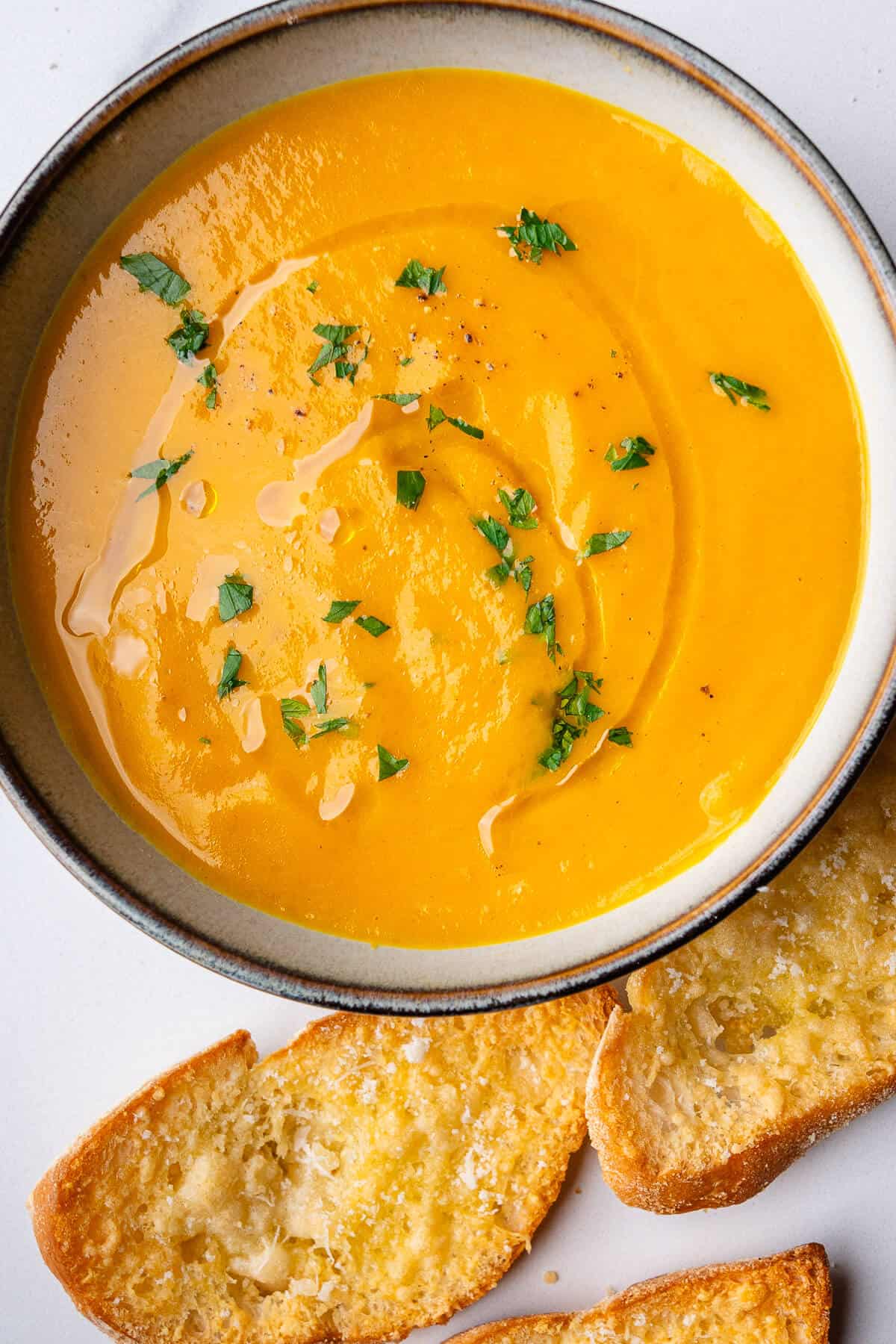 Bowl of soup with crostini on the side