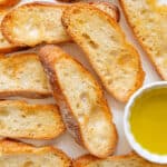 Crostini pieces baked with salt on top and olive oil on the side