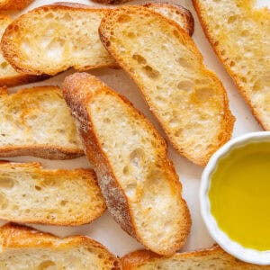 Crostini pieces baked with salt on top and olive oil on the side