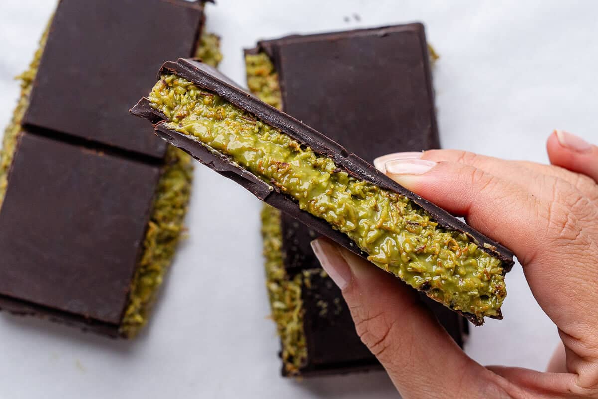 Piece of Dubai chocolate being held up to show the inside