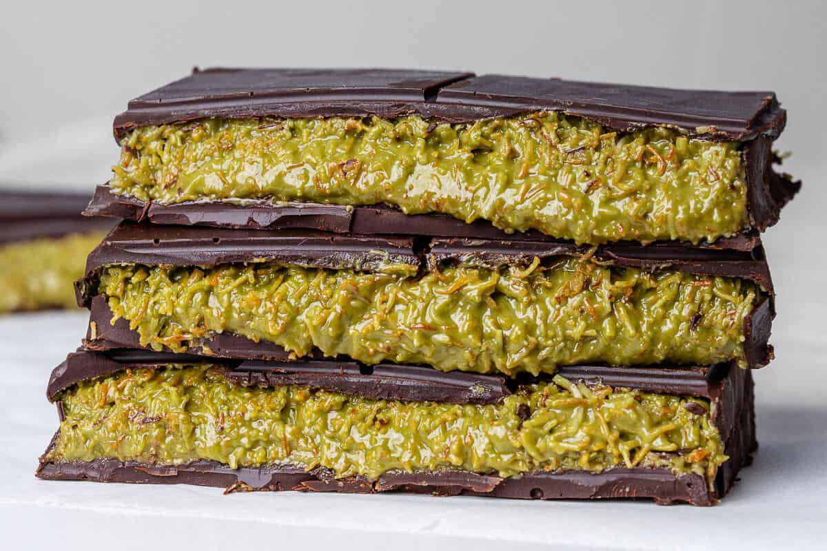 Stack of Dubai chocolate pieces show the pistachio fill