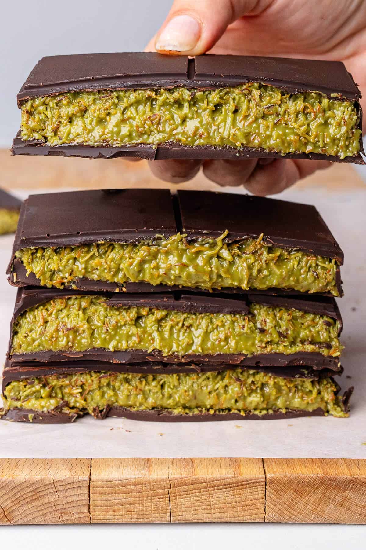 Piece of chocolate being picked up from a stack