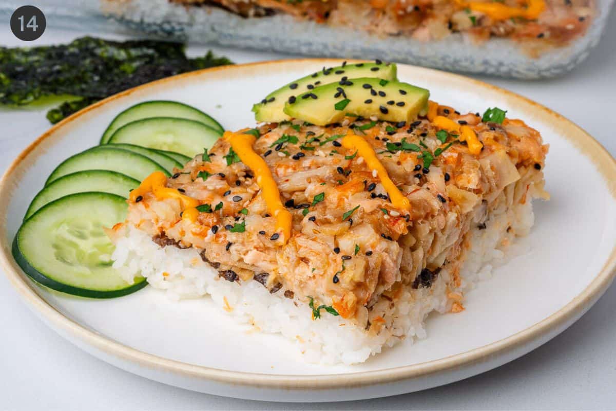 Piece of bake served with nori sheets, avocado and cucumber