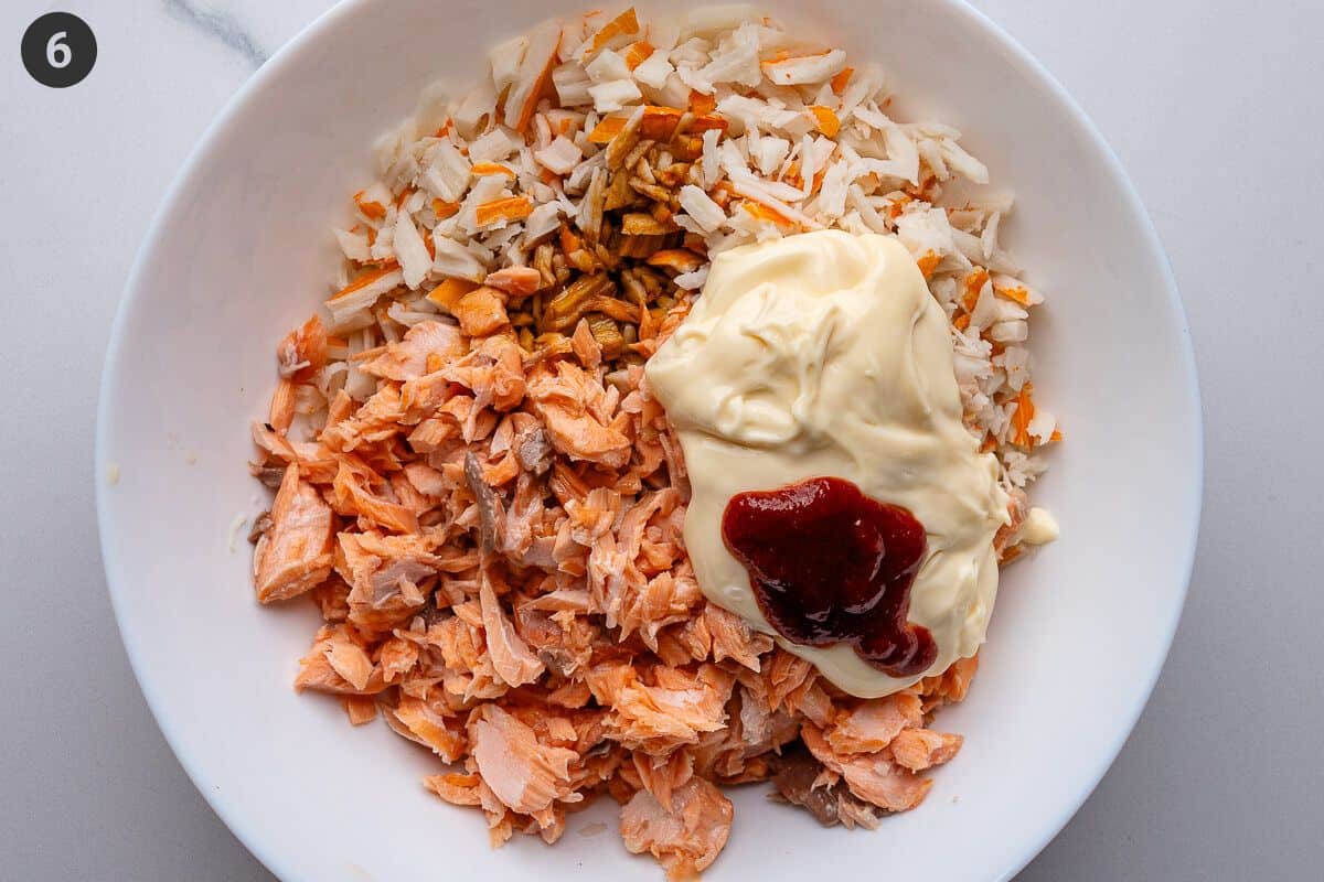 Sauces added to salmon and surimi in a bowl