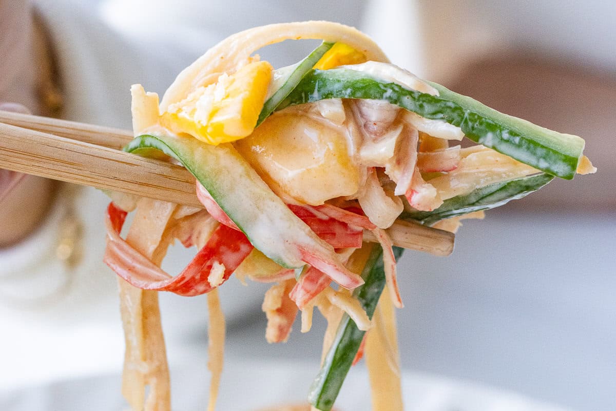 Close up of chopsticks to show creamy kani salad