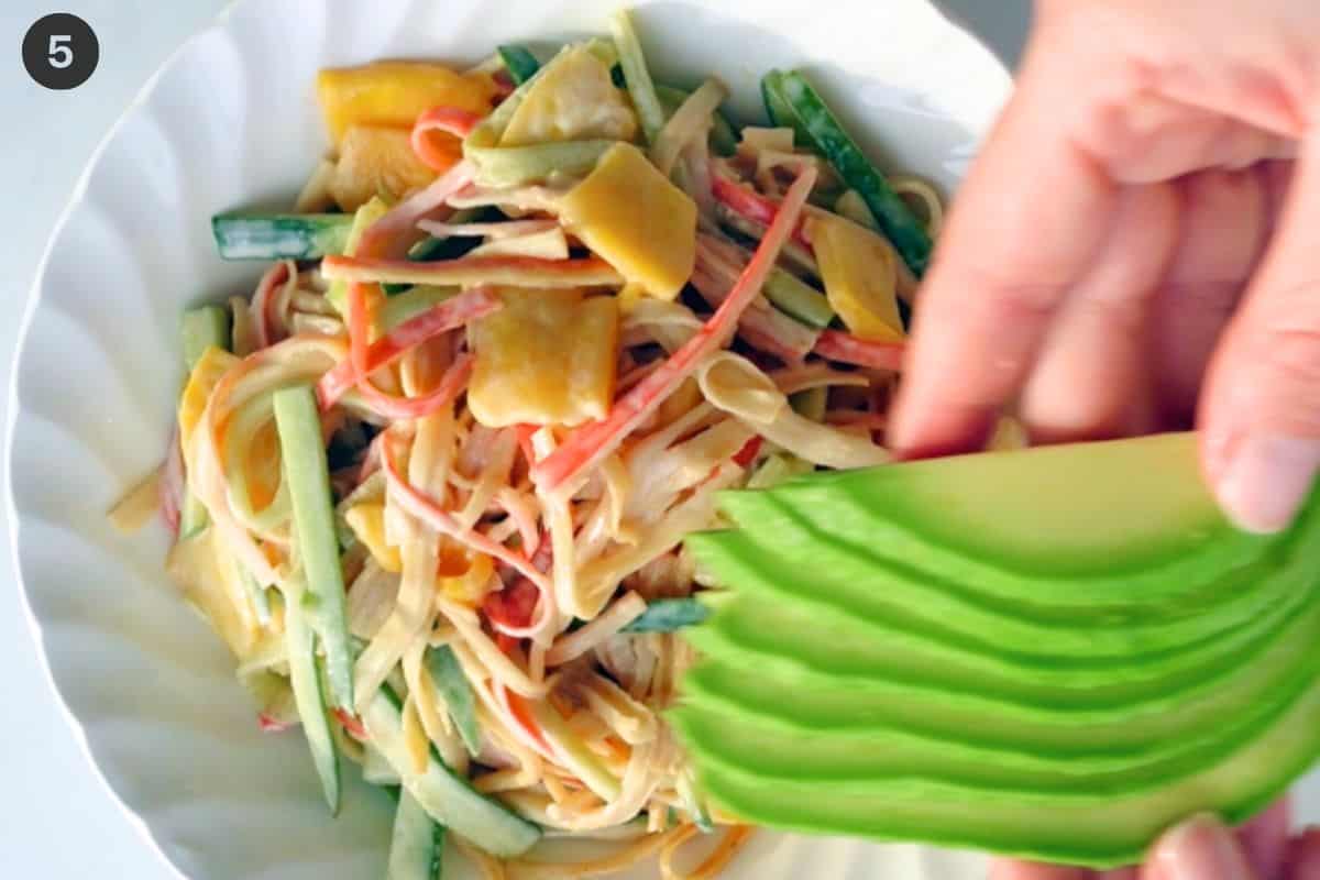 Bowl mixed and avocado slices placed on top