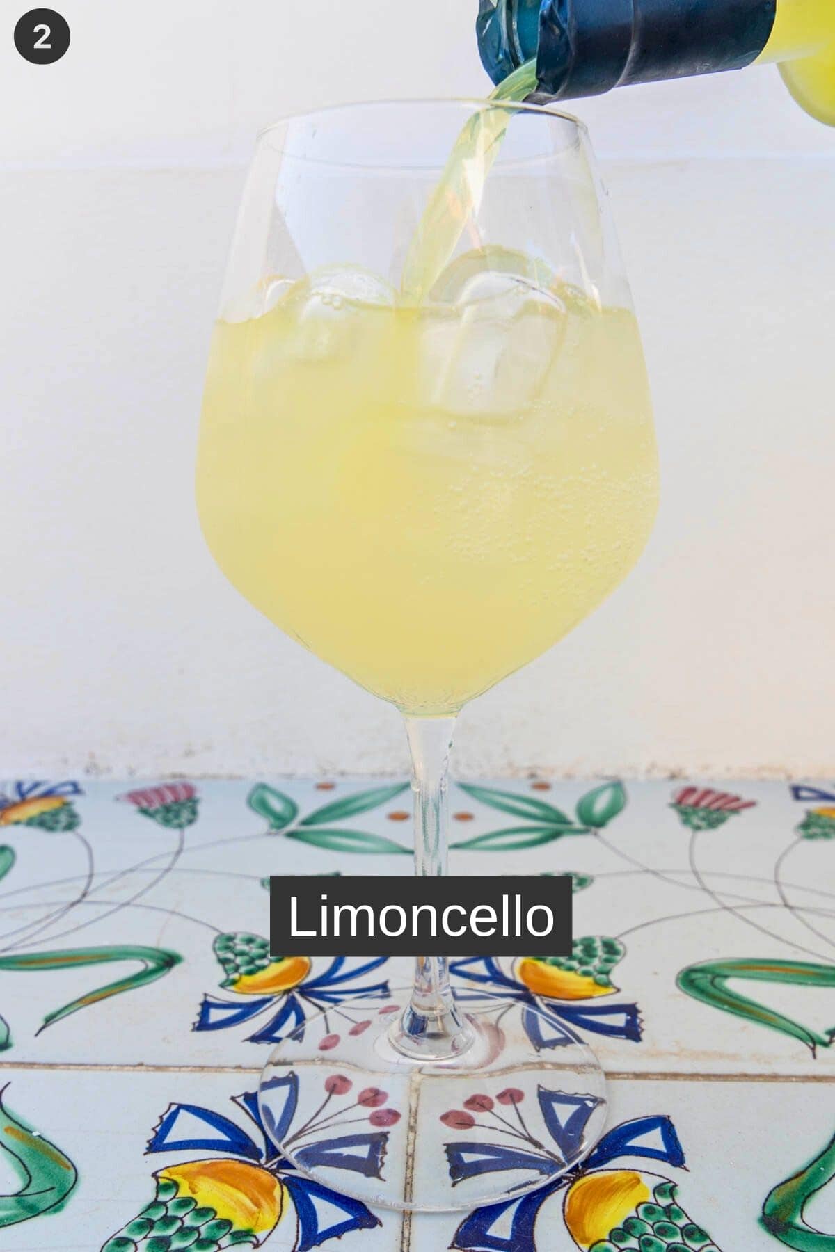 Limoncello added to a glass with proseco and ice
