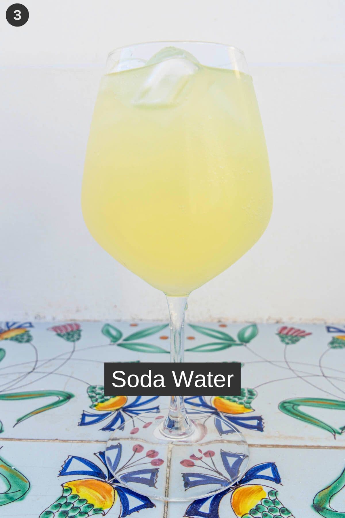 Soda water added to a glass with proseco limoncello and ice