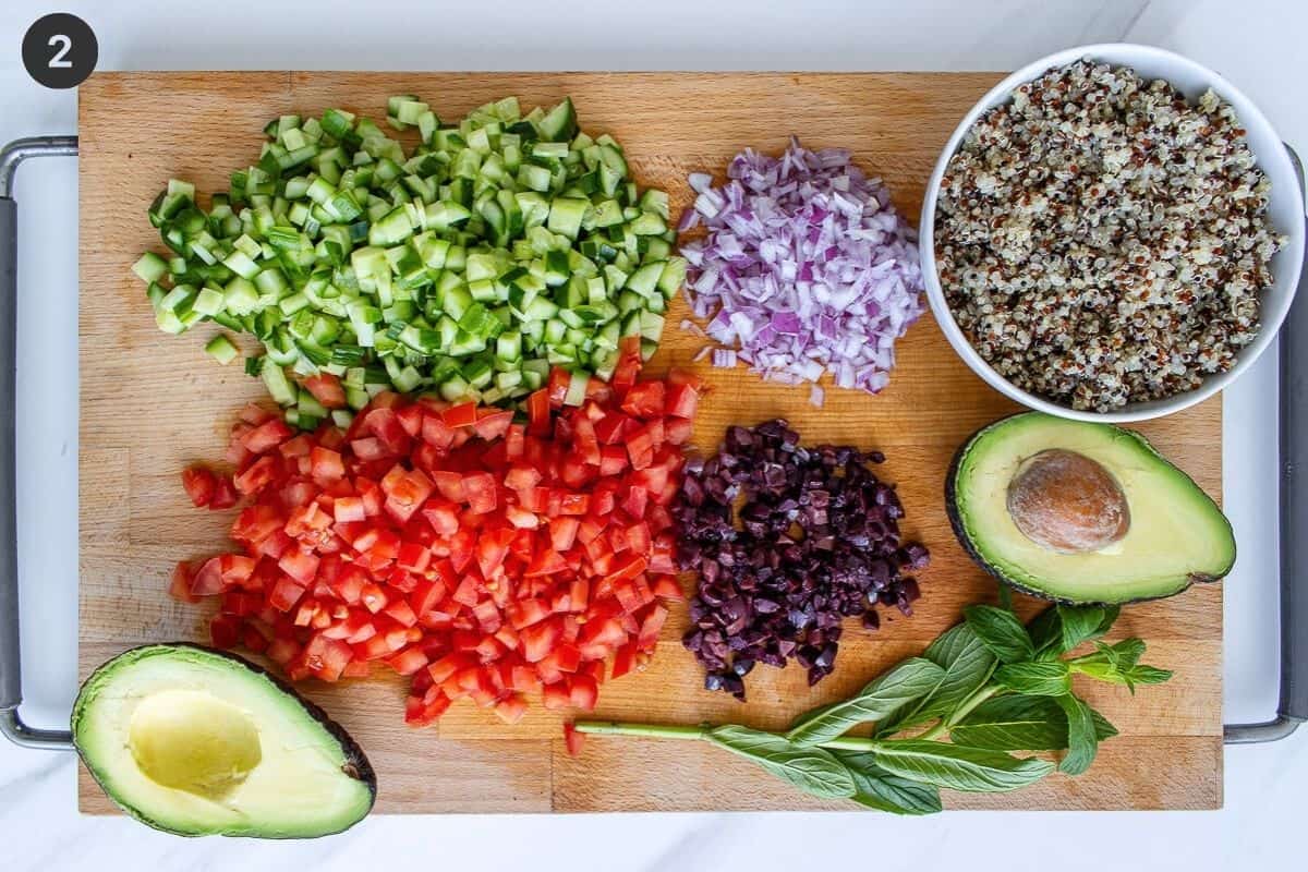 Chopped ingredients on a cutting board with avocado and quinoa