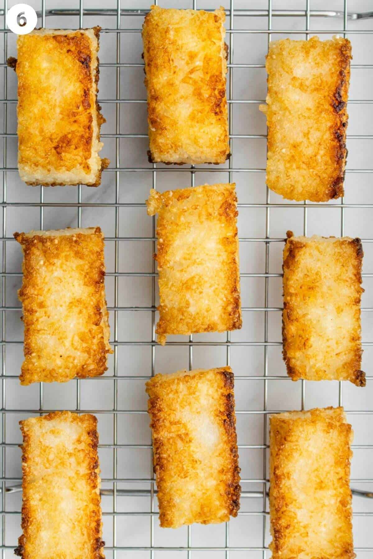 Crispy rice pieces resting on a wire rack