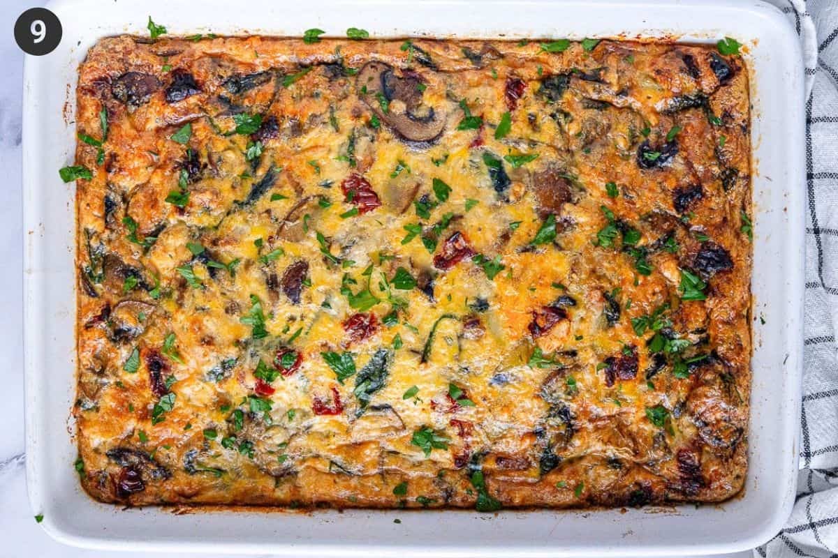 Breakfast Casserole straight out of the oven topped with fresh parsley