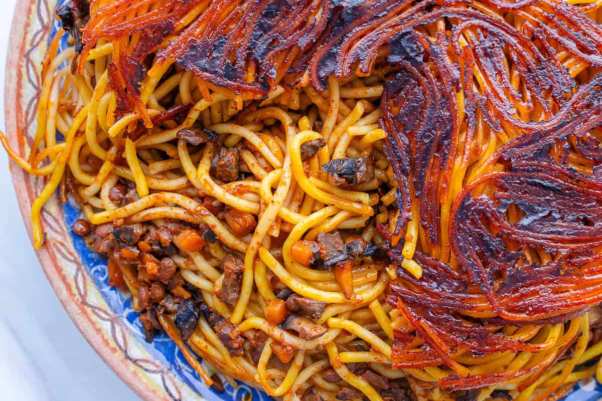 Tahdig piece missing from the top of Makaroni Persian spaghetti to show the inside