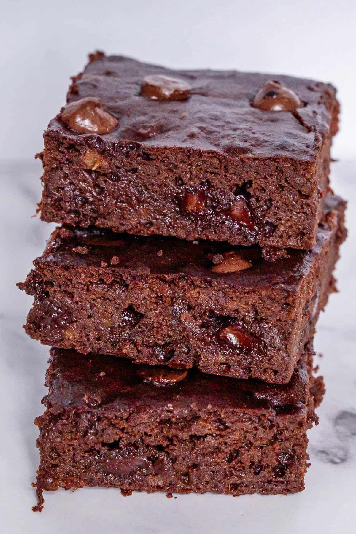 Stack of three pieces of sweet potato brownies