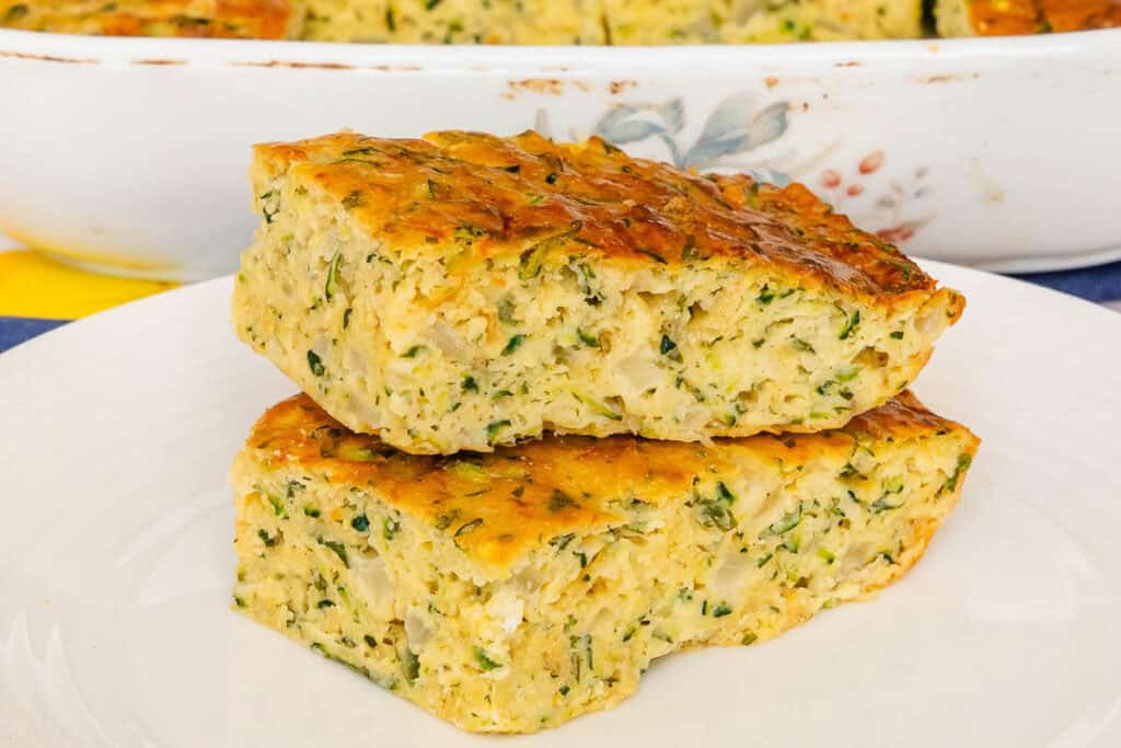 Two pieces of zucchini slice stacked on a plate