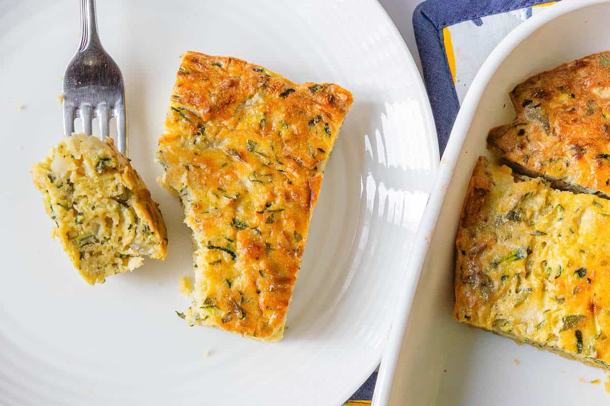 Slice served on a plate with a fork and tray on the side
