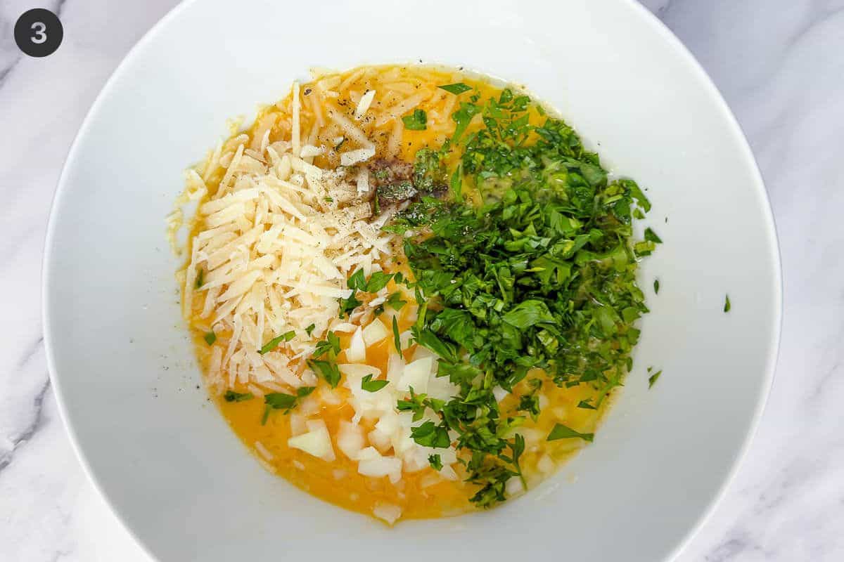 Cheese, onion and parsley added to egg bowl