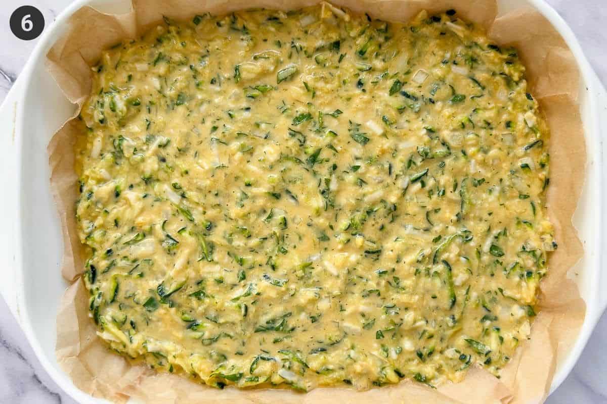 Batter added to an oven dish lined with parchment paper