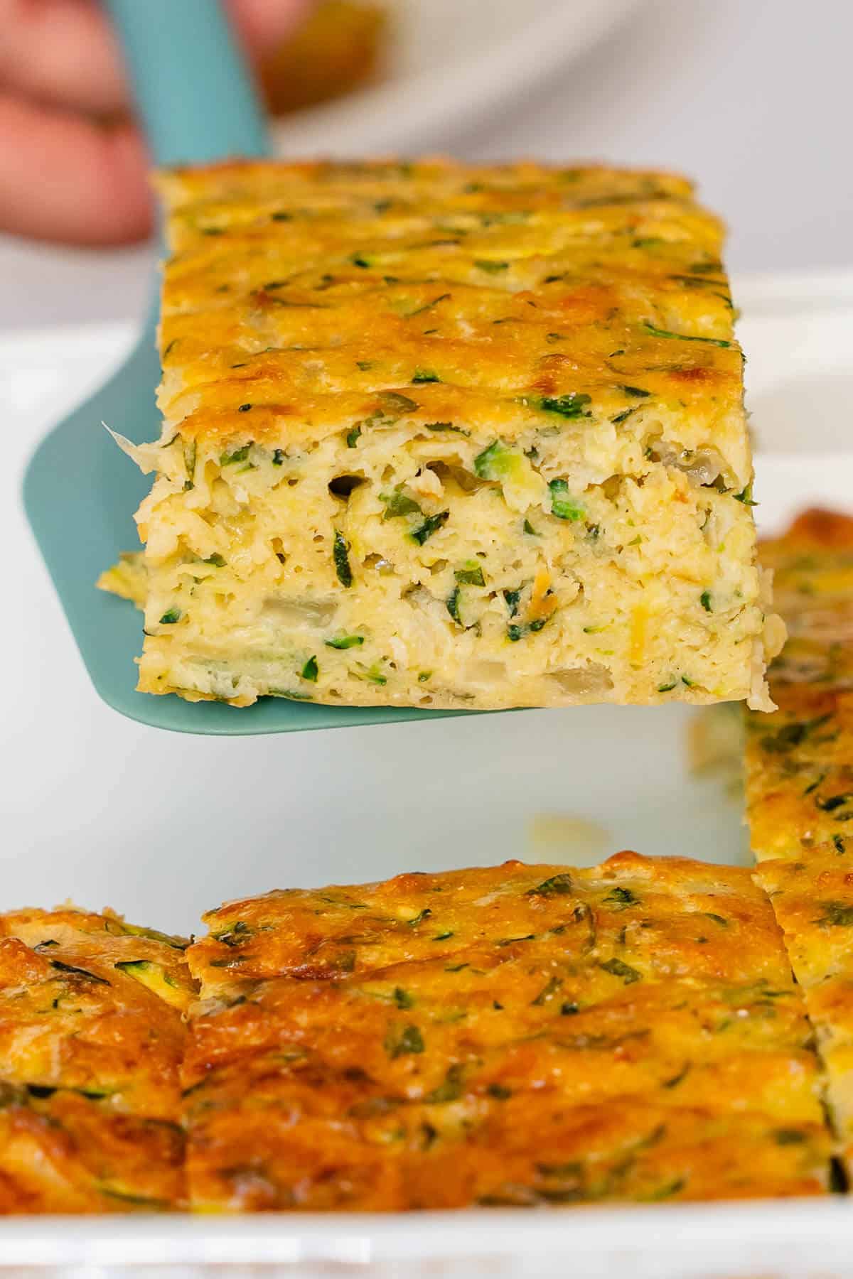Piece of Zucchini Slice coming out of the oven tray