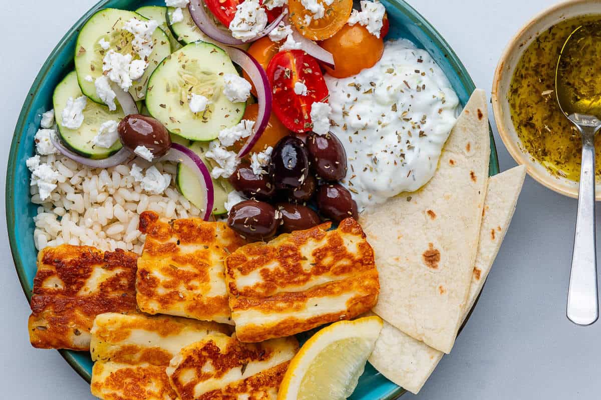 Greek bowl with brown rice, veggies, halloumi and tzatziki