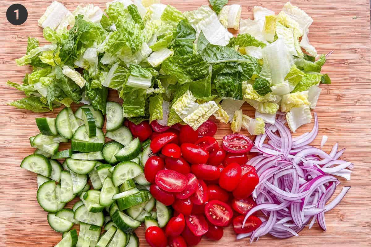 Salad ingredients being prepared on a cutting board