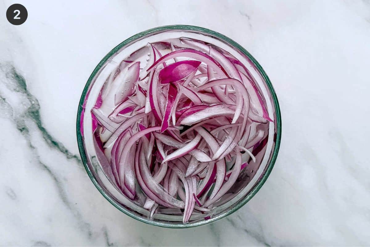 Red onion being soaked in water to make more milder flavor