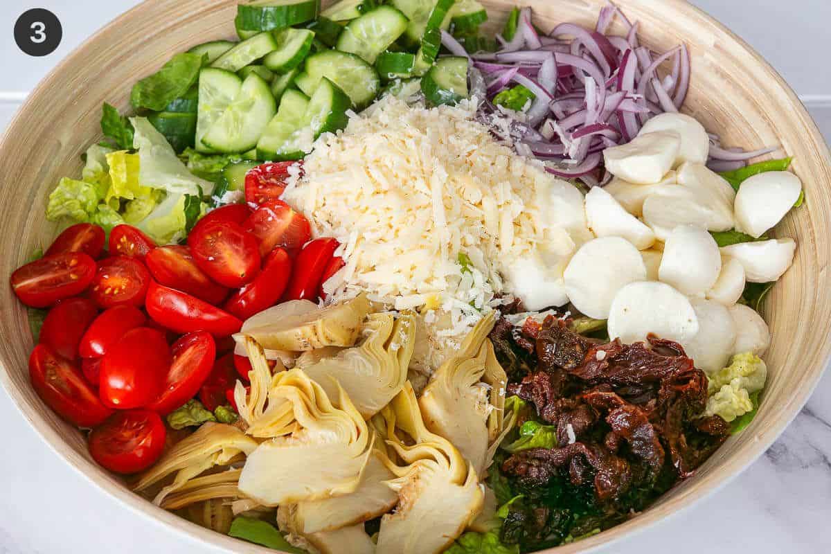 Large bowl with salad ingredients placed in separate sections