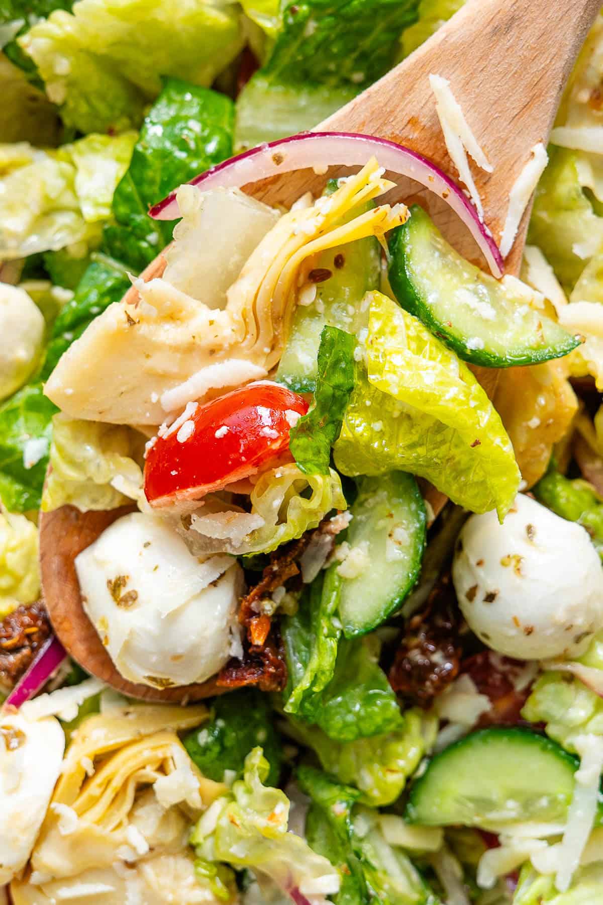 Close up of Italian Chopped Salad on a wooden spoon