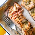 Piece of baked dijon salmon which has been flaked with a fork