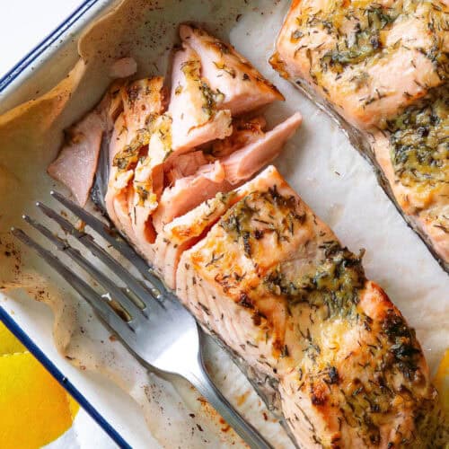 Piece of baked dijon salmon which has been flaked with a fork