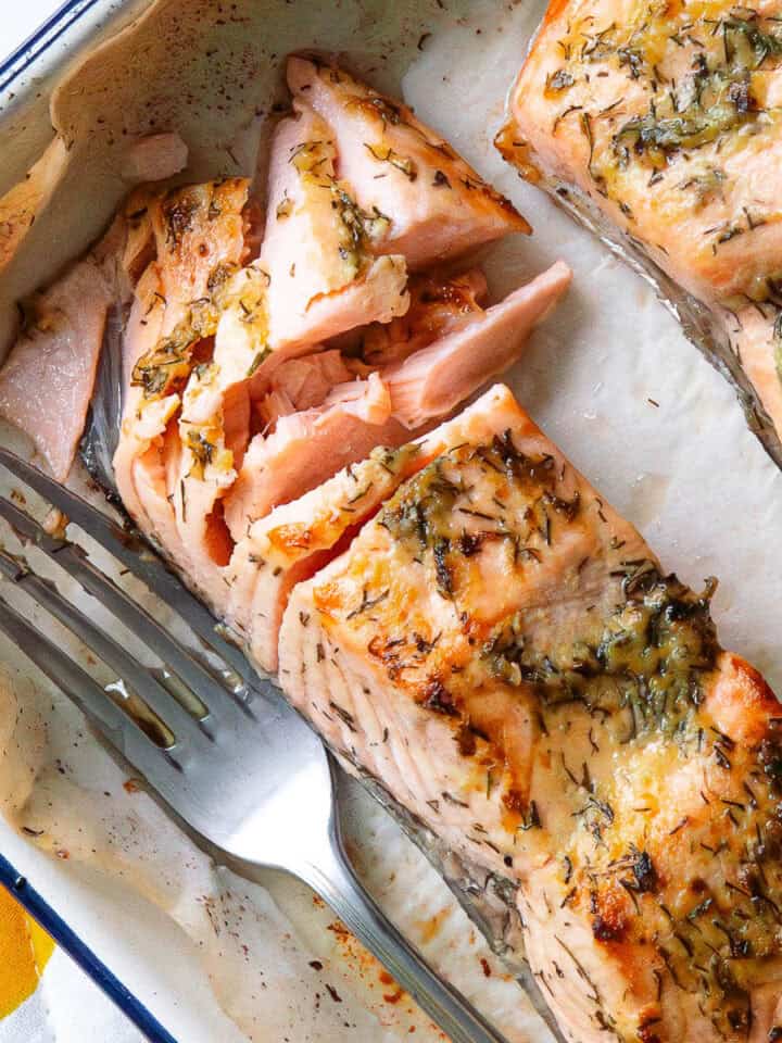 Piece of baked dijon salmon which has been flaked with a fork