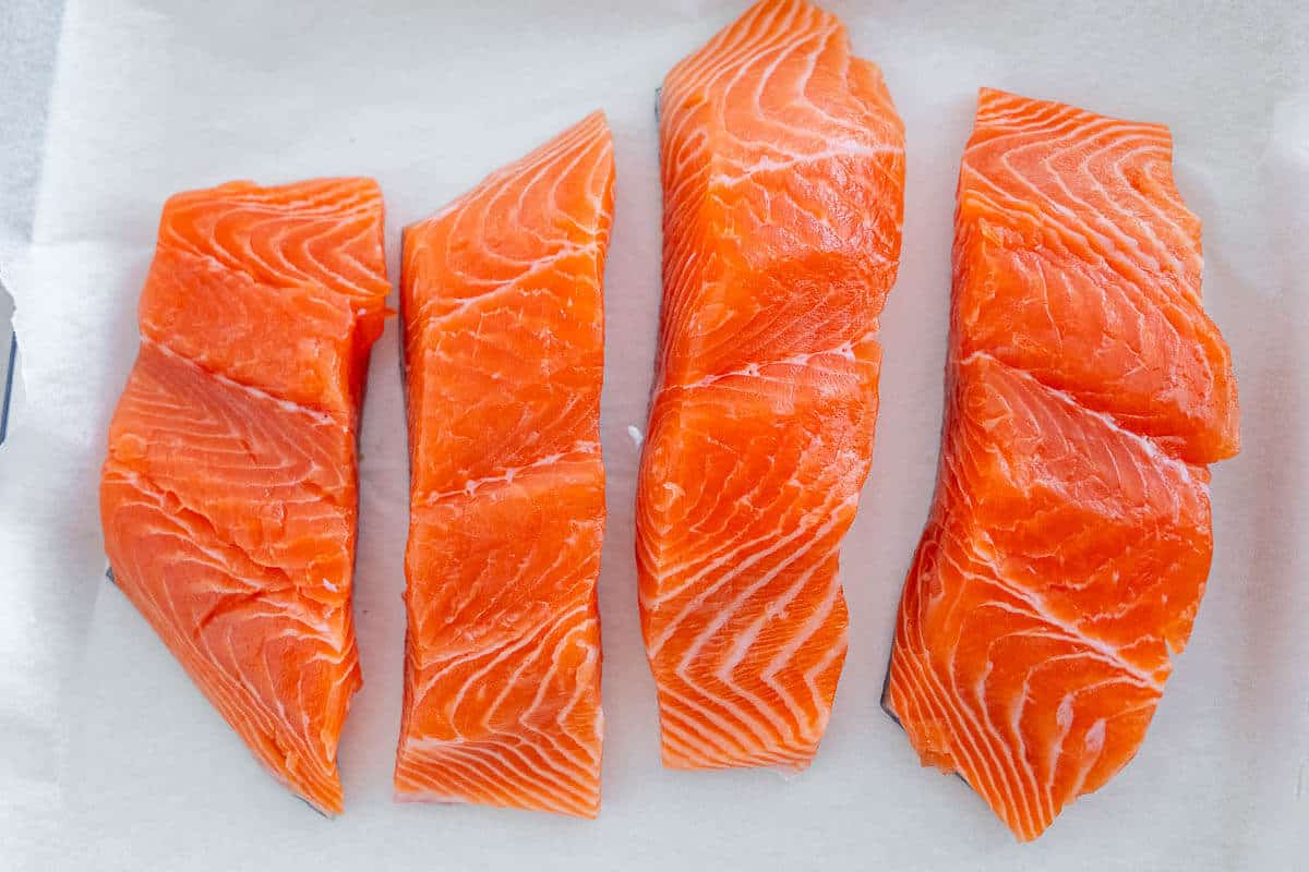 Four pieces of raw salmon fillets
