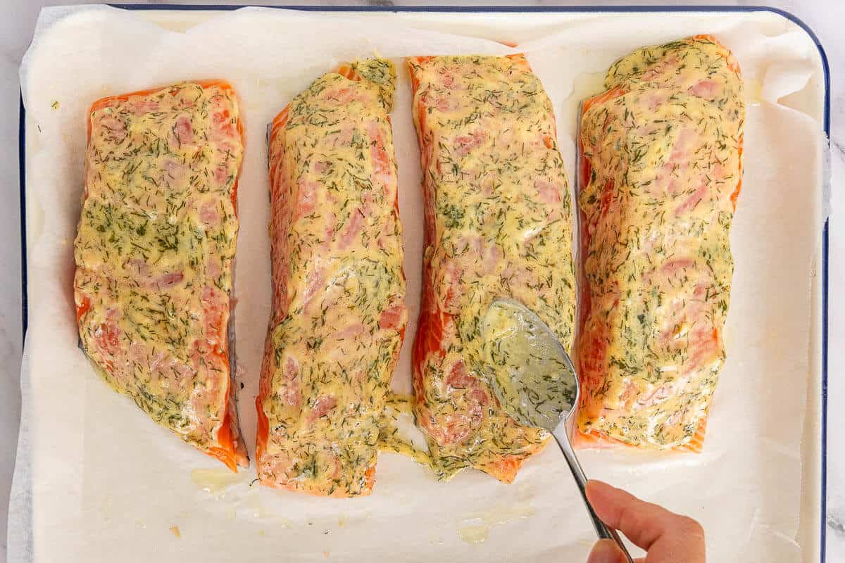 Dijon dressing added to salmon fillets and left to marinate