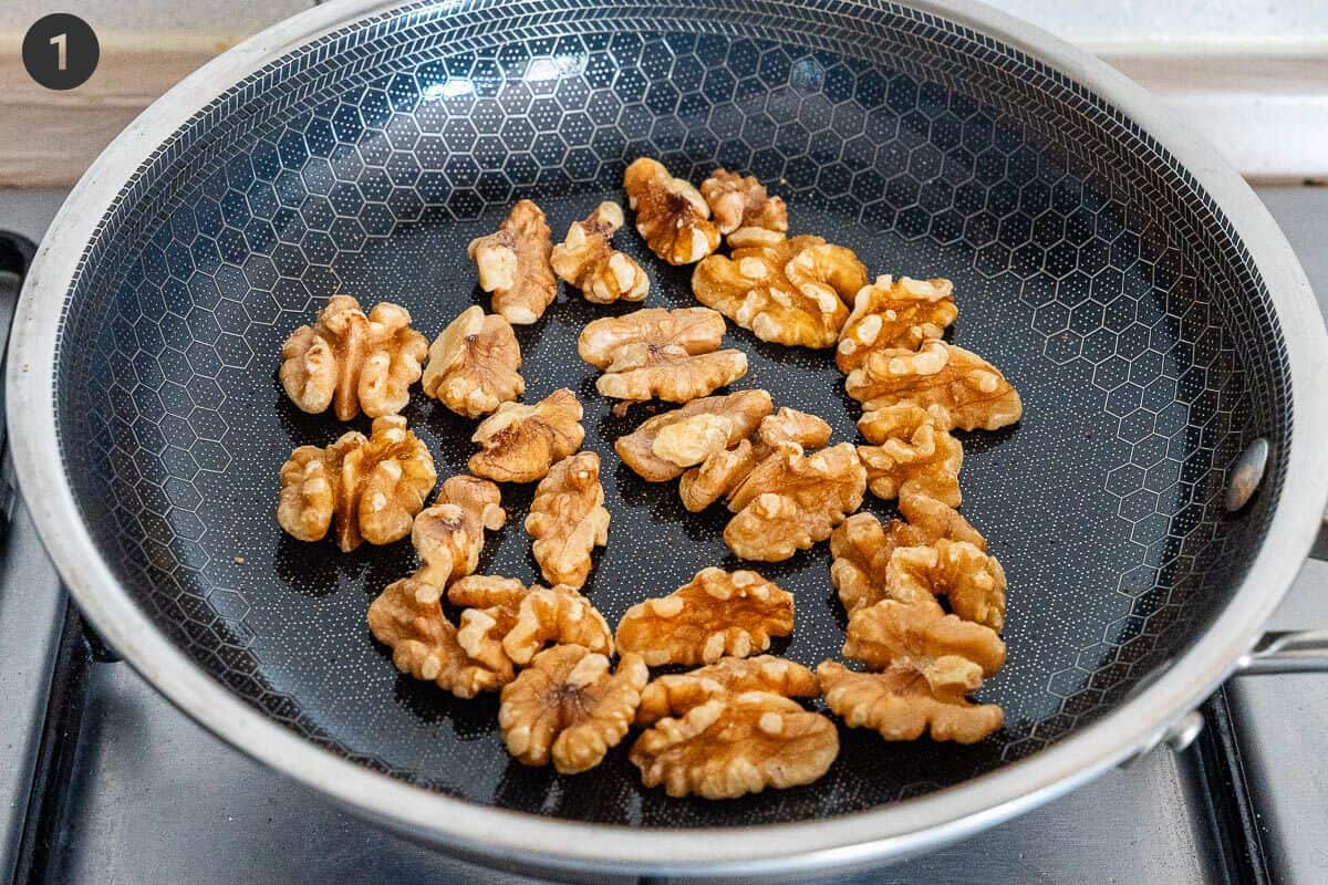 Walnuts being toasted on a pan