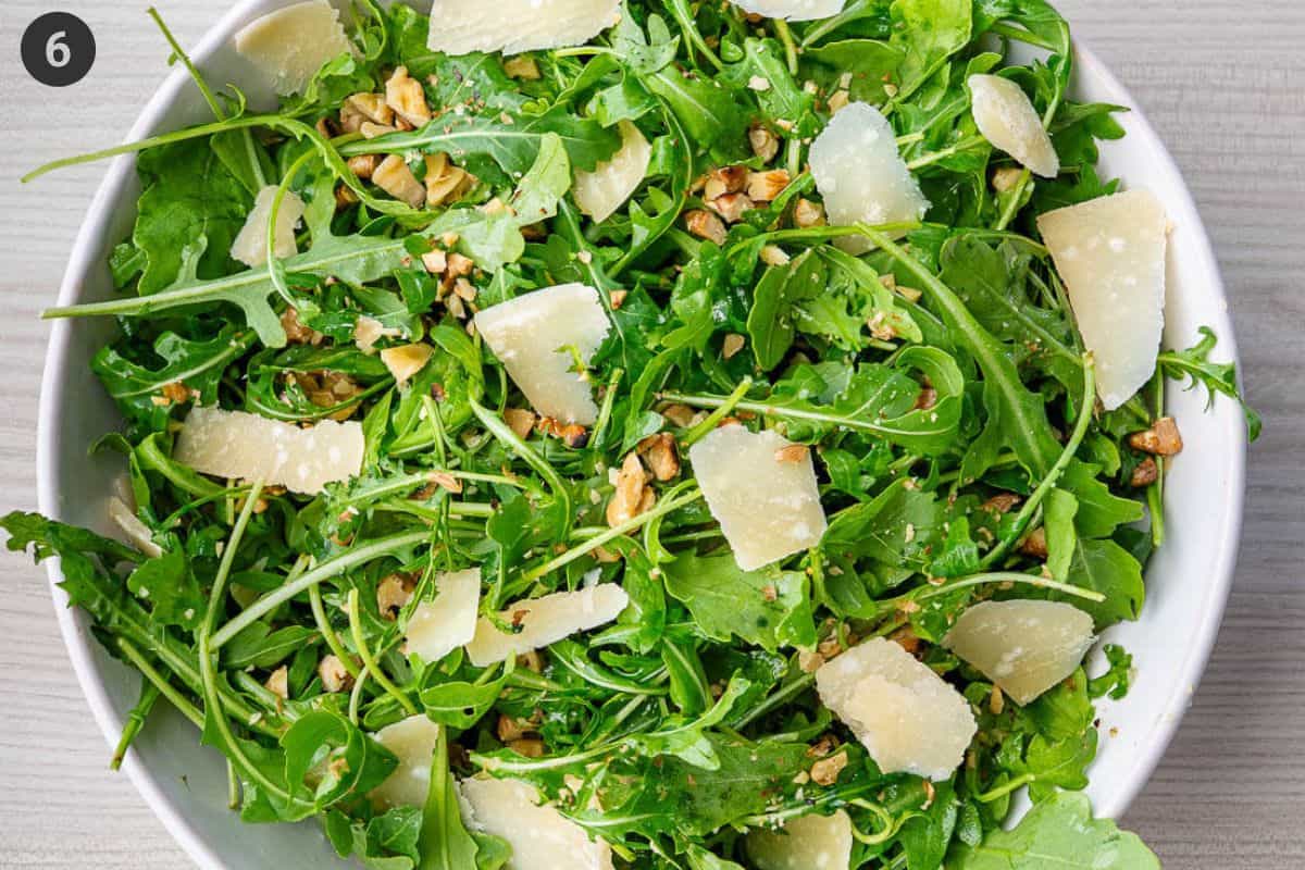 Salad is then topped with grated parmesan and chopped walnuts
