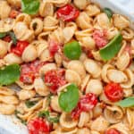 Baked Feta Pasta topped with fresh basil in an oven dish